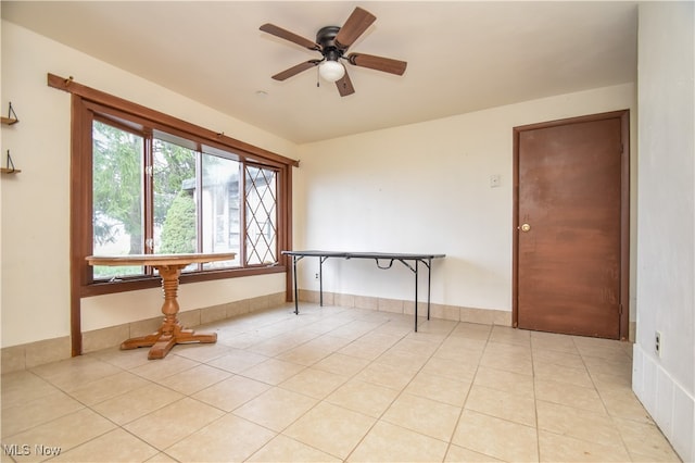 empty room featuring ceiling fan and light tile patterned floors