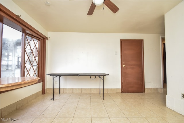 interior space with ceiling fan