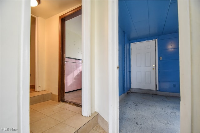 hall featuring light tile patterned floors