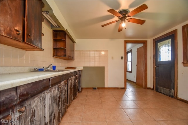 kitchen with sink, ceiling fan, backsplash, and light tile patterned floors