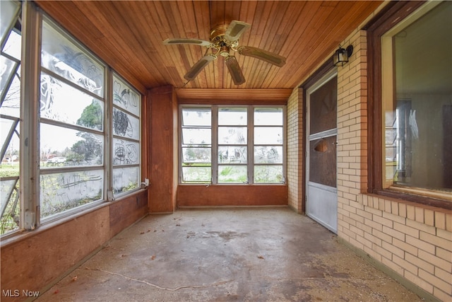 unfurnished sunroom featuring wooden ceiling and ceiling fan