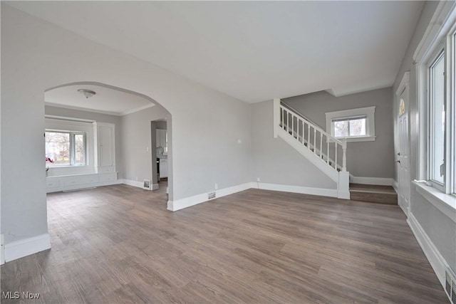 unfurnished room with a healthy amount of sunlight and hardwood / wood-style flooring