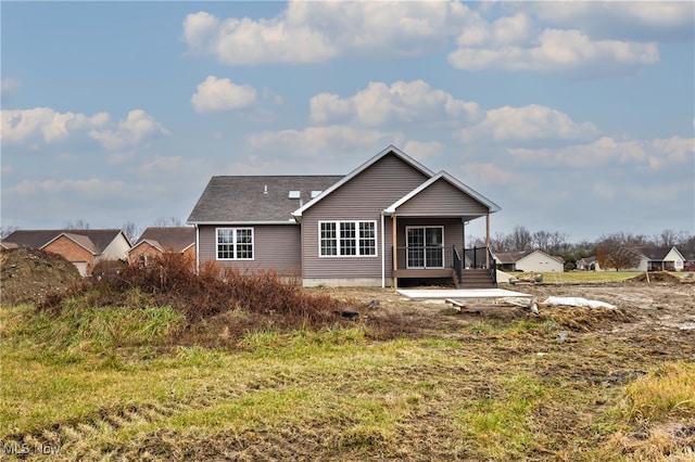 back of property featuring a porch