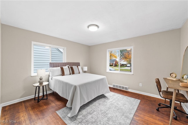 bedroom with dark hardwood / wood-style flooring