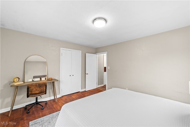 bedroom featuring dark hardwood / wood-style floors and a closet