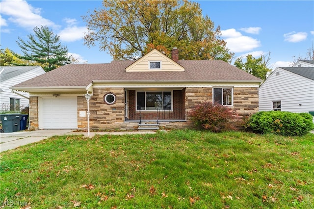 view of front of property with a garage and a front yard