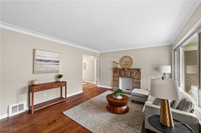 living room featuring ornamental molding, a fireplace, and dark hardwood / wood-style floors