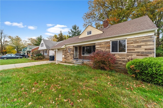 view of front of home featuring a front yard, covered porch, and a garage