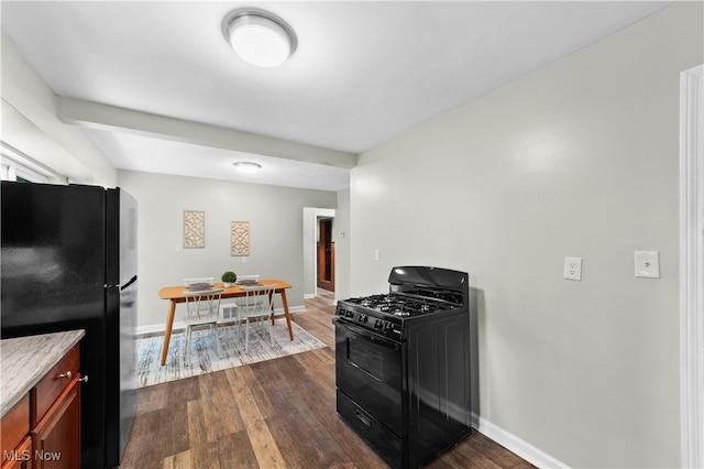 kitchen featuring dark wood-type flooring and black appliances