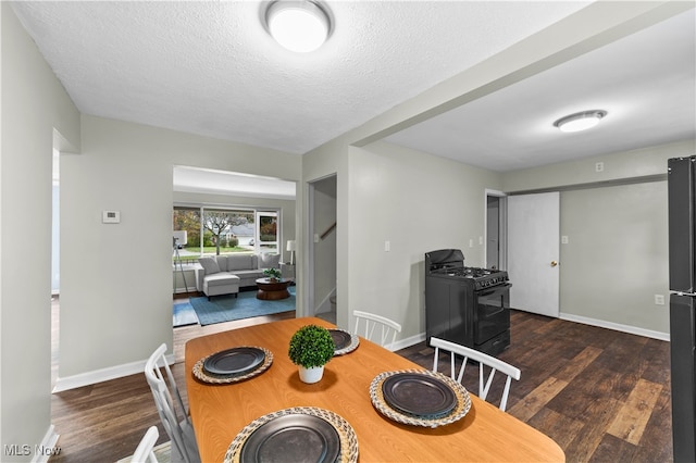 dining room featuring a textured ceiling and dark hardwood / wood-style floors