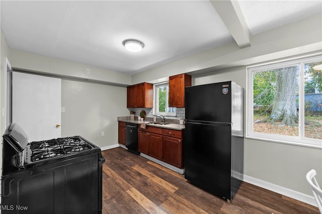 kitchen with sink, black appliances, beam ceiling, backsplash, and dark hardwood / wood-style flooring