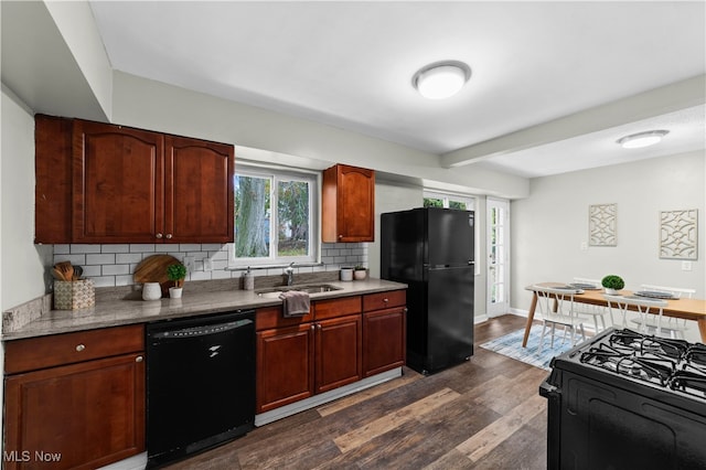 kitchen with dark hardwood / wood-style flooring, black appliances, sink, and tasteful backsplash