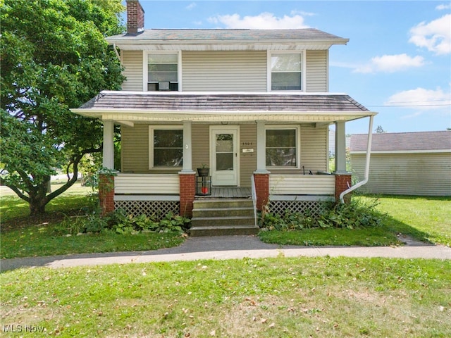 view of front facade with a porch and a front lawn