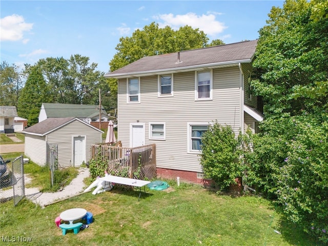 back of property with a storage unit and a lawn