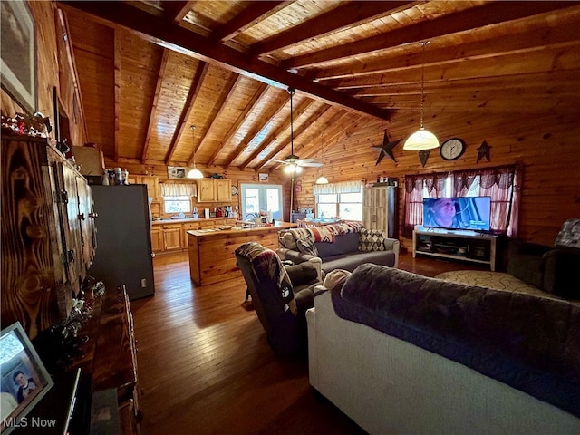 living room featuring wood walls, hardwood / wood-style flooring, wooden ceiling, ceiling fan, and vaulted ceiling with beams