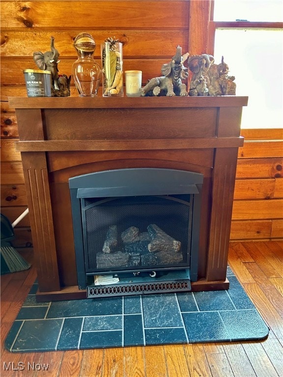 details featuring hardwood / wood-style floors and a fireplace