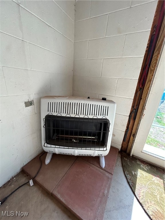 interior details featuring heating unit and concrete floors