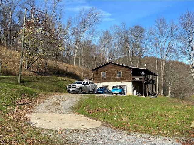 view of side of property with a lawn and a deck