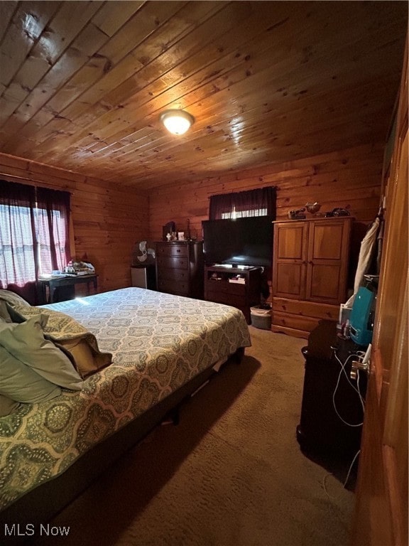 carpeted bedroom featuring wood walls and wooden ceiling