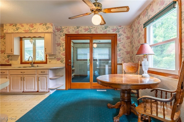 dining area with sink and ceiling fan