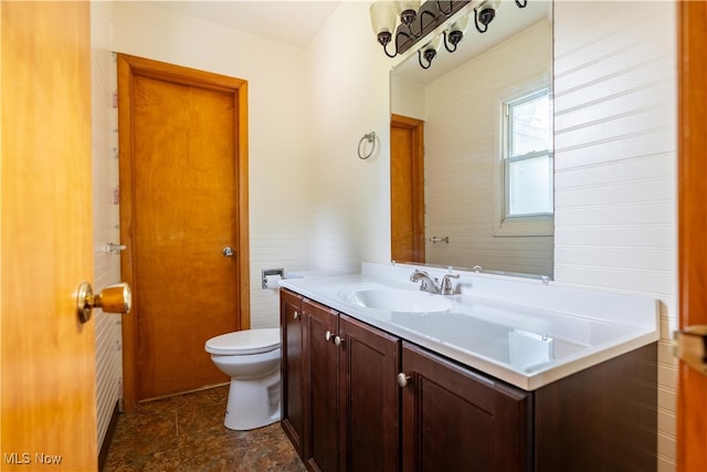 bathroom with toilet and vanity