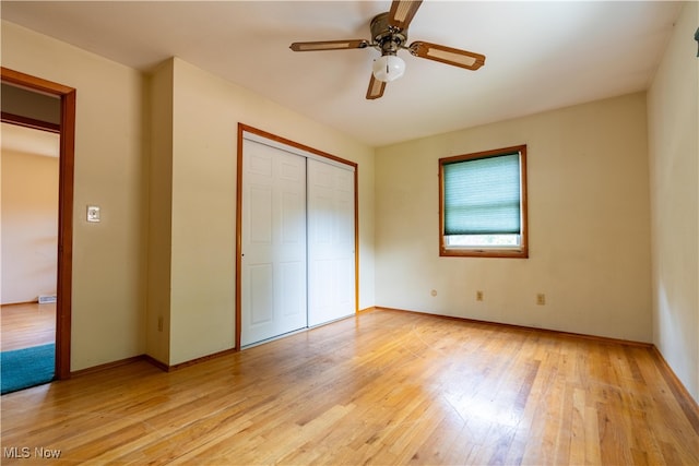 unfurnished bedroom featuring light wood-type flooring and ceiling fan