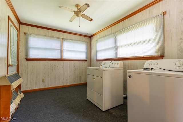 laundry room with ceiling fan, washer and dryer, dark colored carpet, and crown molding