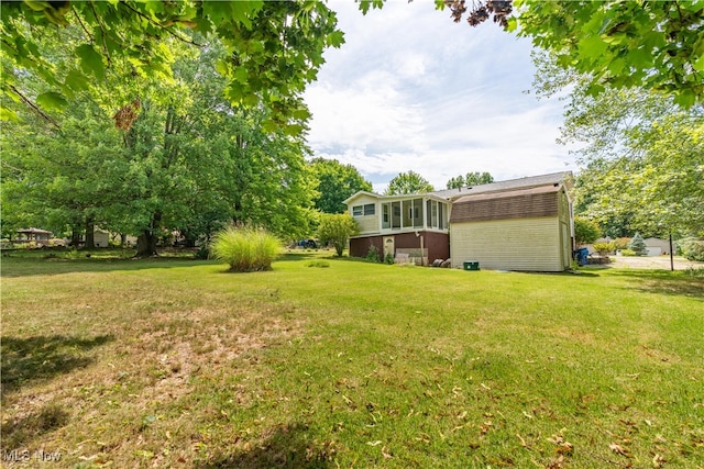 view of yard featuring a sunroom