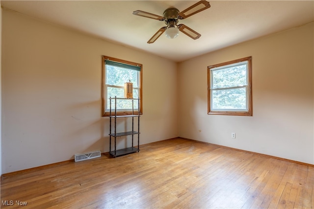 unfurnished room with light hardwood / wood-style flooring, ceiling fan, and plenty of natural light