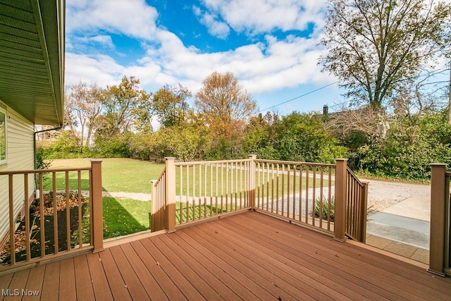 wooden deck with a lawn