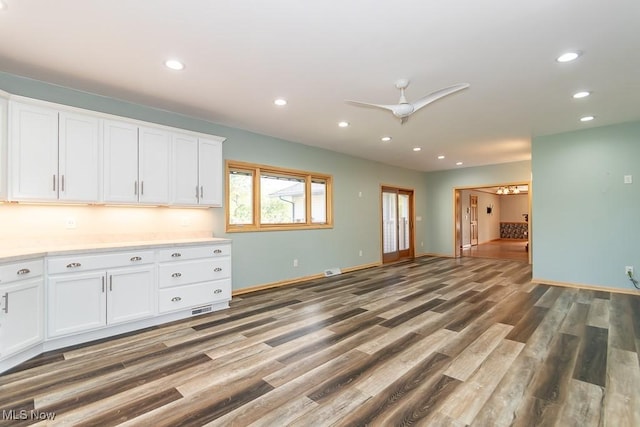 kitchen featuring ceiling fan, white cabinetry, and dark wood-type flooring