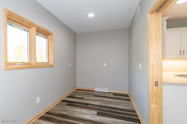 spare room with dark wood-type flooring