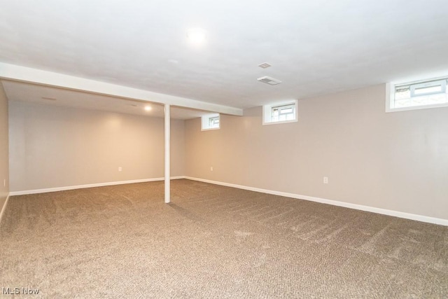 basement with plenty of natural light and carpet