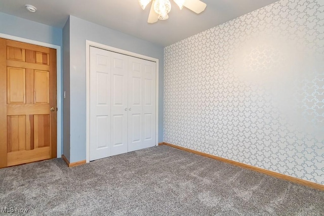 unfurnished bedroom featuring ceiling fan, carpet floors, and a closet