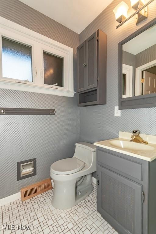 bathroom featuring tile patterned floors, vanity, and toilet