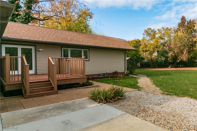 rear view of house featuring a yard and a deck