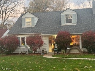 new england style home featuring a front lawn