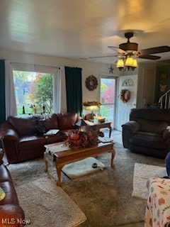 carpeted living room featuring a wealth of natural light and ceiling fan