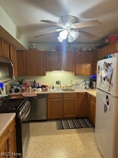 kitchen featuring appliances with stainless steel finishes, sink, and ceiling fan