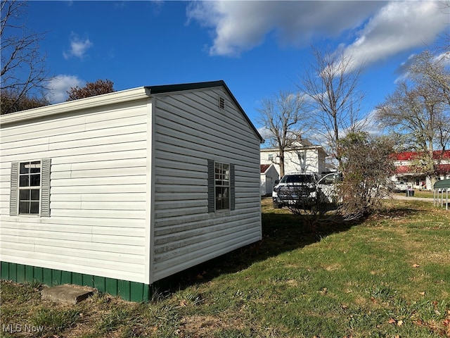 view of side of property with a yard