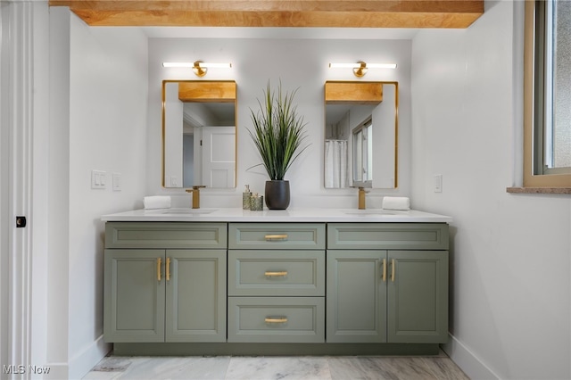 bathroom with beamed ceiling and vanity