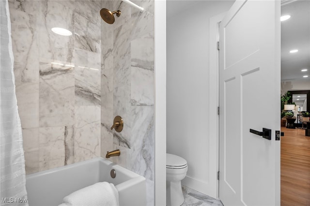 bathroom featuring wood-type flooring, toilet, and shower / bath combination with curtain