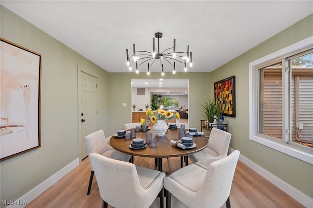 dining space featuring a chandelier and light hardwood / wood-style flooring