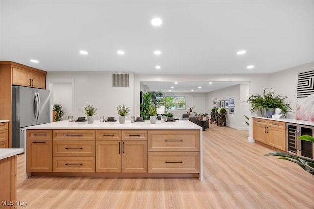 kitchen with wine cooler, light wood-type flooring, and stainless steel fridge