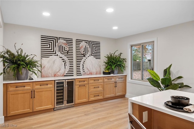 kitchen featuring light hardwood / wood-style floors and wine cooler