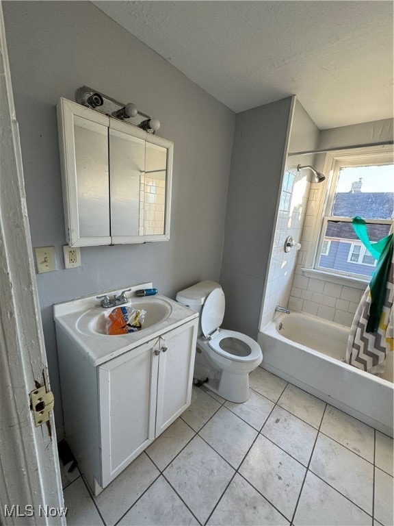 full bathroom featuring a textured ceiling, tile patterned flooring, vanity, and shower / bath combination with curtain