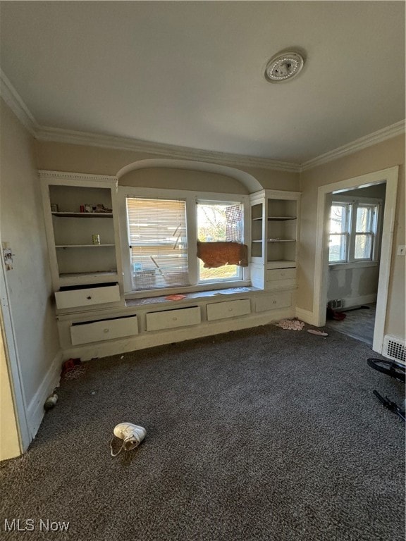 spare room featuring ornamental molding, carpet, and a wealth of natural light