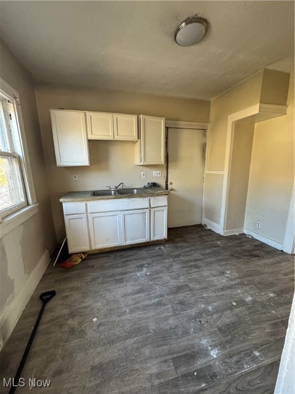 kitchen featuring white cabinets and sink