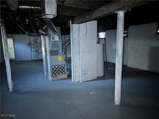 basement featuring water heater and heating unit