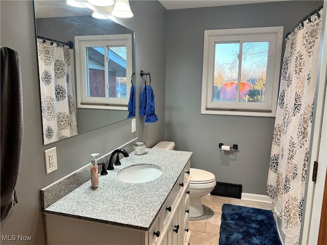 bathroom featuring tile patterned floors, vanity, and toilet